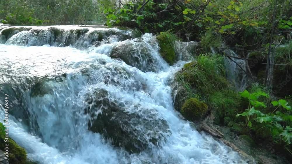 Cascading water along a series of large moss covered rocks in Plitvice Lakes National Park in Croatia, Europe at ¼ speed Cascading water along a series of large moss covered rocks in Plitvice Lakes National Park in Croatia, Europe at ¼ speed
