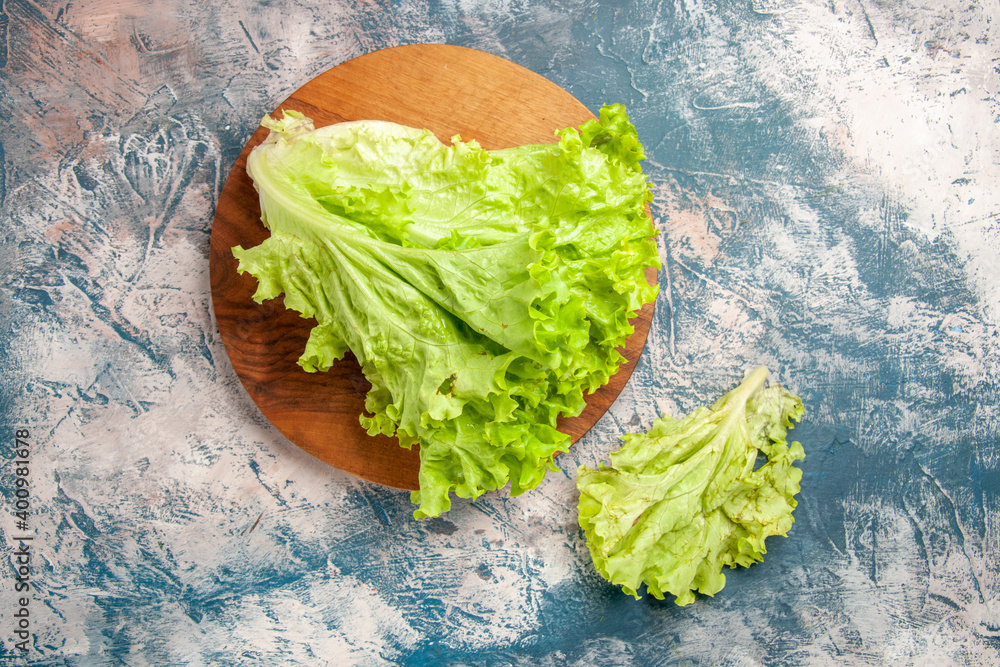 Fototapeta top view fresh green salad on light-blue background color photo ripe meal salad