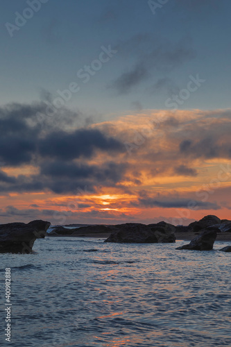 Sunrise on the sea coast with rocks