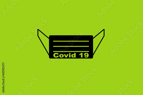 Illustration of black mask with words covid 19 on green background