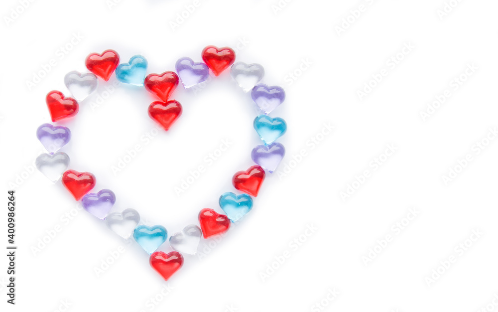 Small multicolored hearts lie in the shape of a large heart on a white background. Layout for Valentine's Day. Isolate. View from above. Copyspace Small multicolored hearts lie in the shape of a large heart on a white background. Layout for Valentine's Day. Isolate. View from above. Copyspace