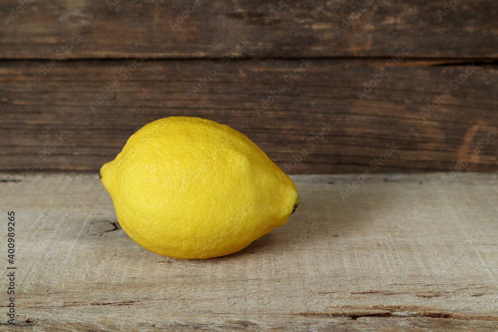 close up photo of the fresh organic natural lemon lime fruit is put on old wooden table with background of old vintage wooden texture wall of the kitchen for making lemon lime sweet sour juice drink