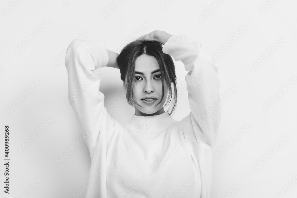 Softness. Portrait of beautiful brunette woman in comfortable soft longsleeve on studio background, black and white. Home comfort, emotions, facial expression, winter mood concept. Copyspace. Softness. Portrait of beautiful brunette woman in comfortable soft longsleeve on studio background, black and white. Home comfort, emotions, facial expression, winter mood concept. Copyspace.