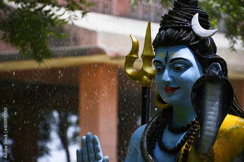 Statue of lord Shiva and Background raining 