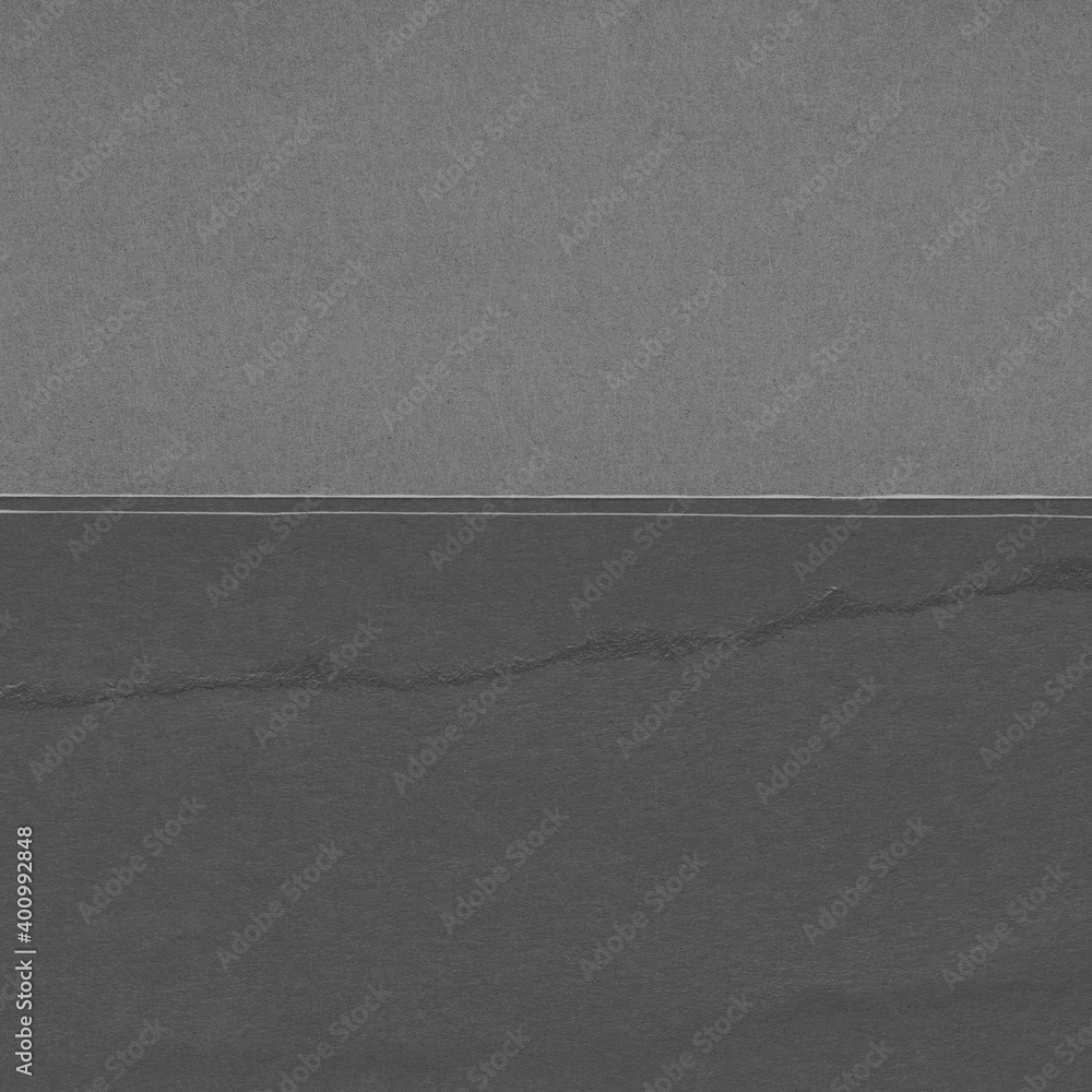 Fototapeta premium Black torn paper collage close-up. Texture made from various paper and cardboard parts. Damaged old paper background. Vintage blank wallpaper. Material design backdrop.