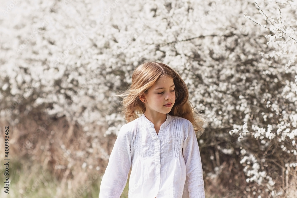 Young blond girl in white blossom in nature. Woman beautiful spring portrait with copy space Young blond girl in white blossom in nature. Woman beautiful spring portrait with copy space