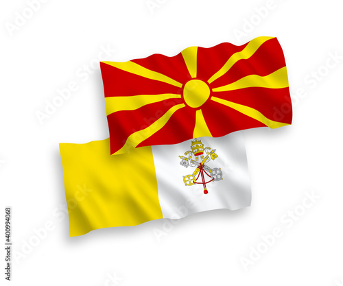 National vector fabric wave flags of Vatican and North Macedonia isolated on white background. 1 to 2 proportion.