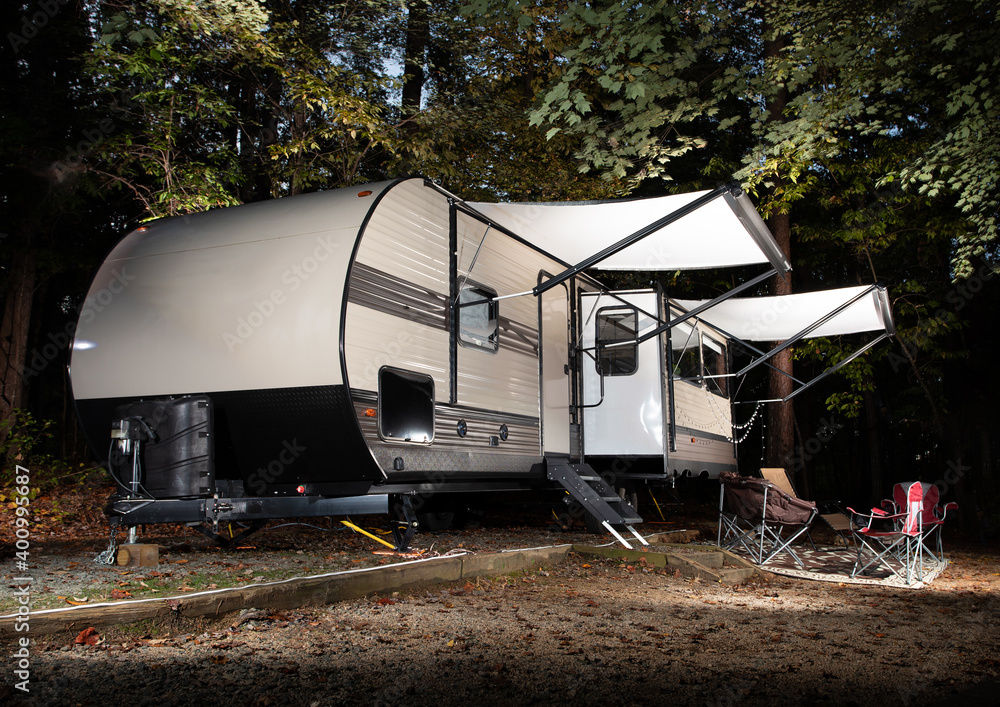 Travel trailer at a camp in North Carolina in a thick forest.