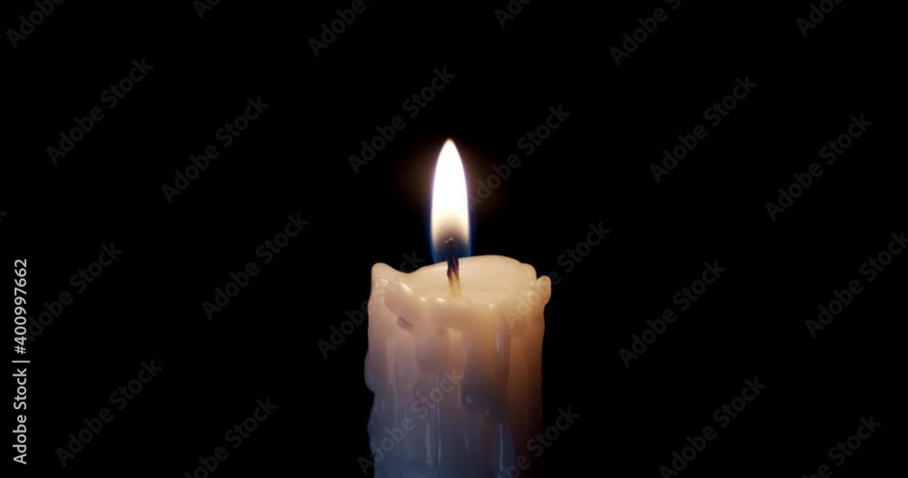 A single white candle burning. Isolated candle burning with dark