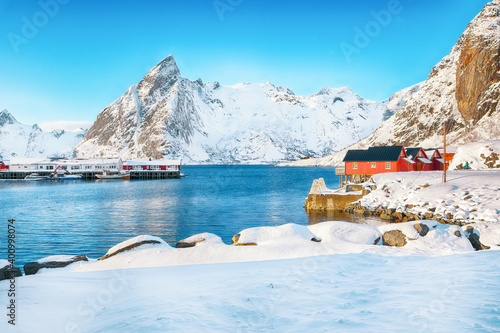 Fantastic winter view on Hamnoy village with port and Olstinden peak on background. © pilat666