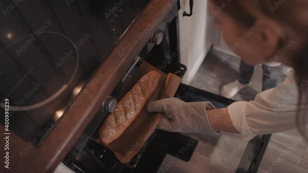 Topview footage of unrecognizable little girl opening oven door and