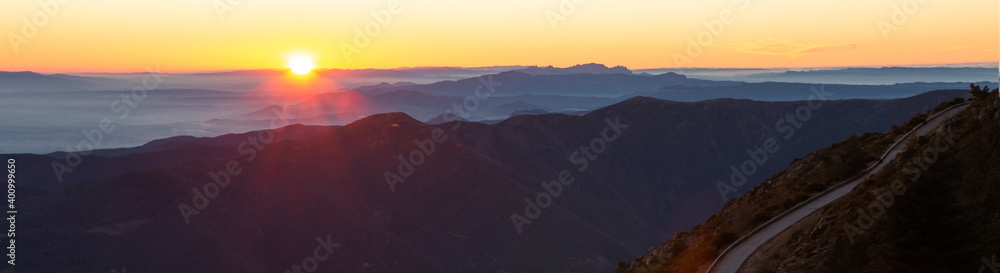 Mountain road with spectacular views of mountain ranges with sunset or sunrise, panoramic view. Montseny, Montserrat, Turo de l'Home, Barcelona, Catalonia, Spain. Travel and outdoors concept.
