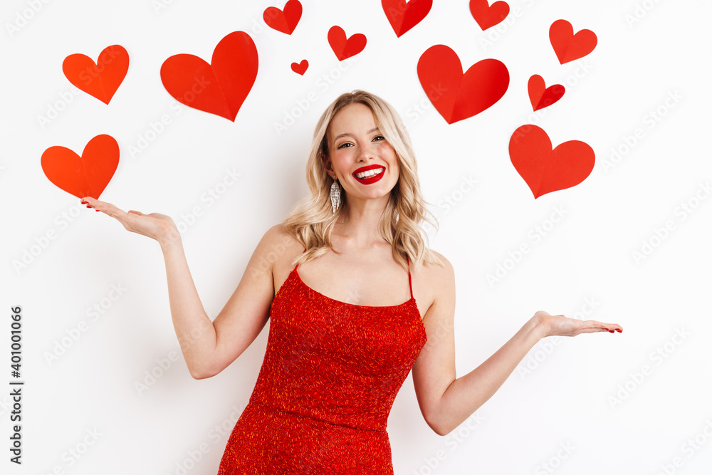 Happy beautiful girl in red dress smiling and throwing up arms Happy beautiful girl in red dress smiling and throwing up arms