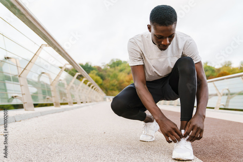 Sporty african man tying shoelace © Drobot Dean