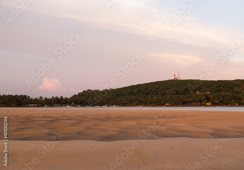 Beautiful empty beach in Goa with tire marks on the sand