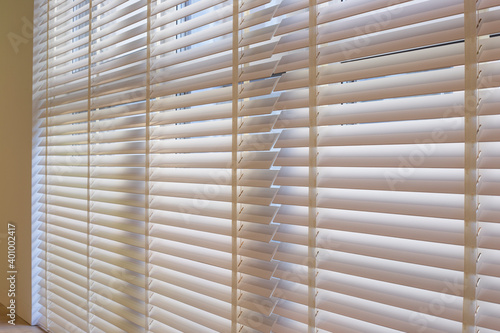 Wallpaper Mural Wood blinds closeup in the interior. Automatic venetian blinds beige color on large windows. Wooden slats 50mm wide. Wood floor, beige walls. Torontodigital.ca