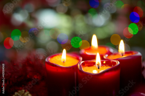 Four red candles for Advent. Christmas background.