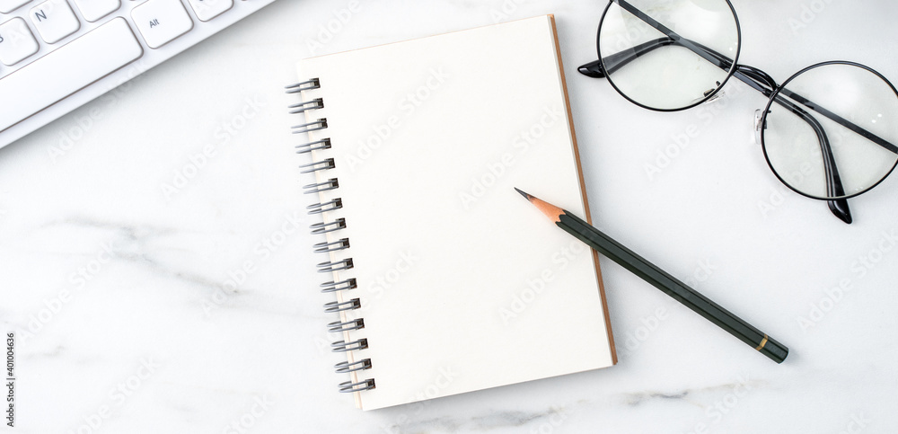 Top view of office table desk cozy work concept on bright marble white background.