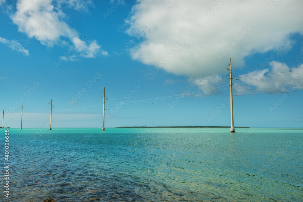  Emerald Bay and electric poles in the water. Florida coast. USA.