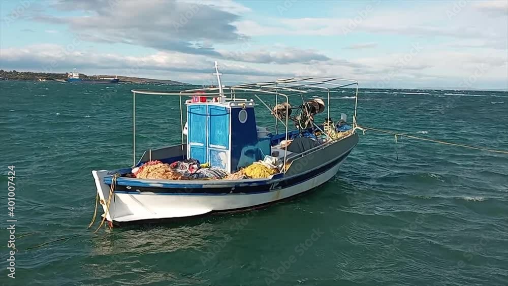 Traditional carvel built Greek fishing boat moored off Lesbos island Traditional carvel built Greek fishing boat moored off Lesbos island