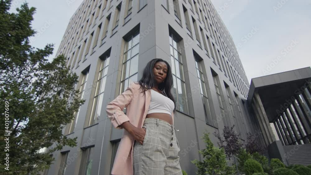 Pretty Young Black Girl Stands On The Street. Beautiful Girl With Long Hair. Pretty Young Black Girl Stands On The Street. Beautiful Girl With Long Hair.