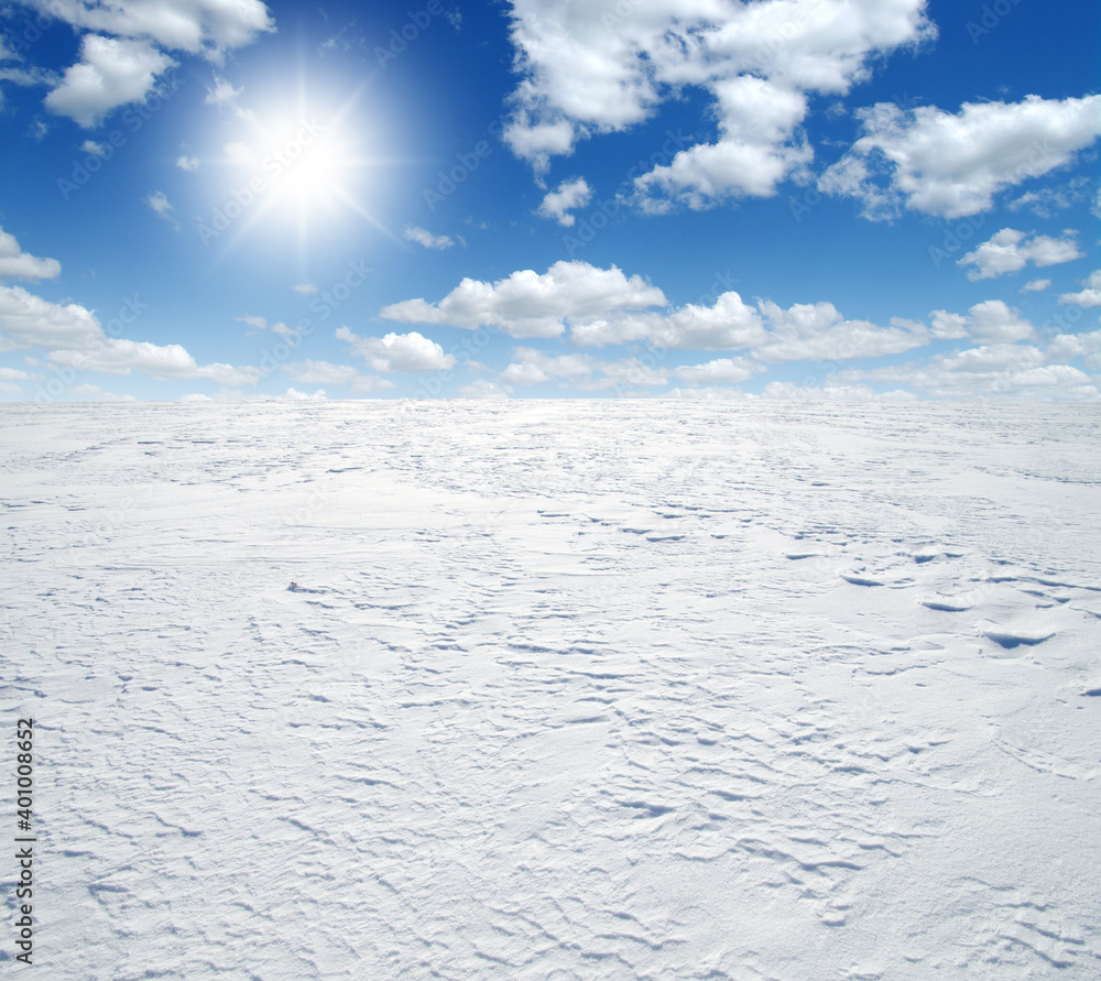 Snowcovered fields on  sky and sun.