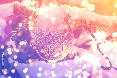 Christmas tree branch with christmas ball and lights, soft focus. Blurred lights background for your ad, poster, banner