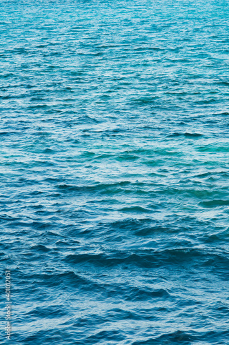 Ripple on the surface of the ocean water close-up. Blue sea background with waves. Caribbean lifestyle themes