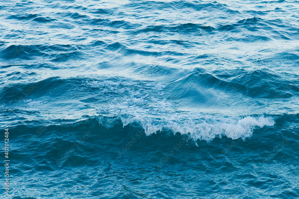 Ripple on the surface of the ocean water close-up. Blue sea background with waves. Caribbean lifestyle themes Ripple on the surface of the ocean water close-up. Blue sea background with waves. Caribbean lifestyle themes