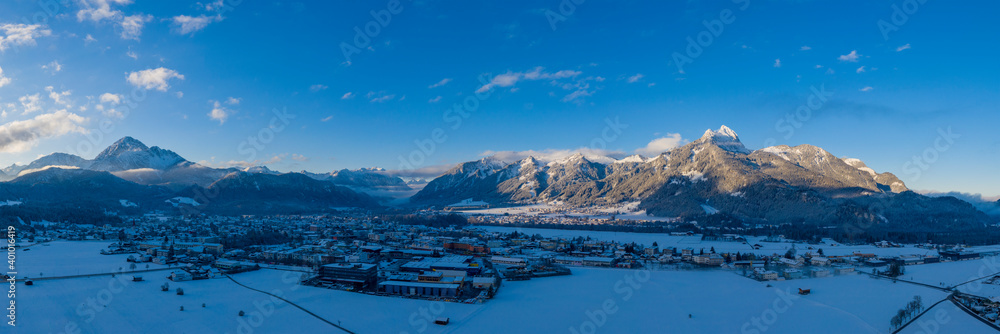 winter panorama in the morning over the valley basin of the Reutte holiday region in Tyrol on a winter day with snow