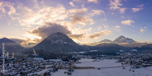 Sun at sunrise behind the Tauern mountain in snowy Reutte and Breitenwang Tyrol in winter photo