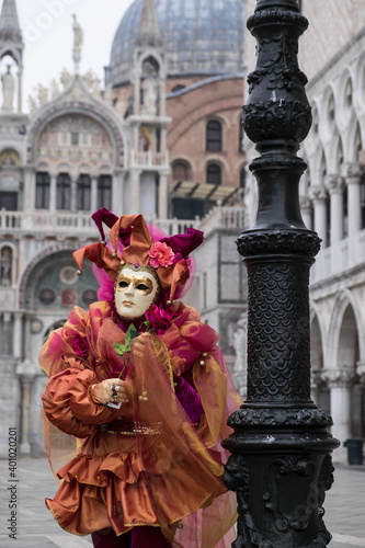 Venice, Italy - February 17, 2020: An unidentified person in a carnival costume in Piazza San Marco attends at the Carnival of Venice.