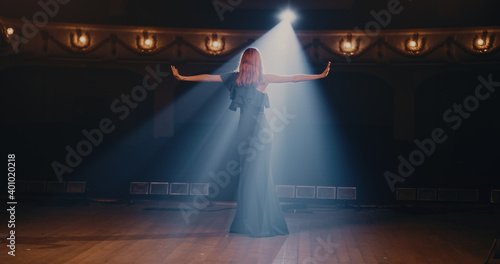 Fototapeta Young actress speaking passionately on stage