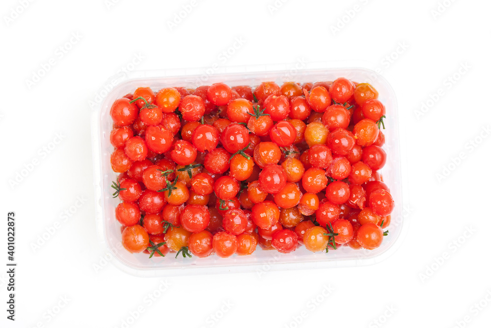 Miniature red cherry tomatoes on a white plate, vegetarian and vegetable products. Studio photo Miniature red cherry tomatoes on a white plate, vegetarian and vegetable products. Studio photo