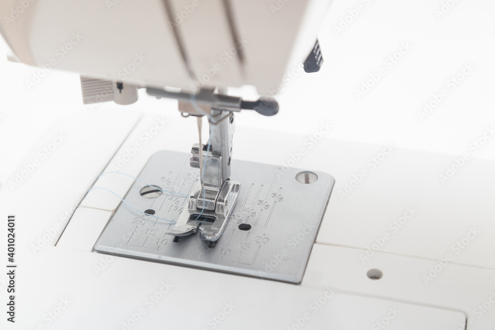 macro of sewing machine needle against white background