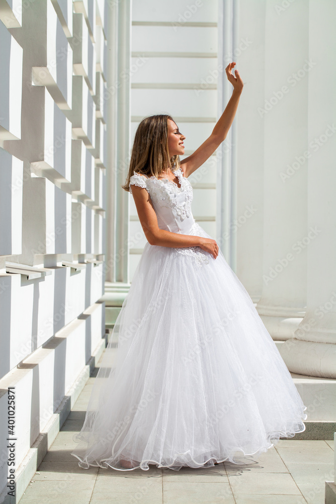 Fototapeta premium Young beautiful girl in ballroom prom dress