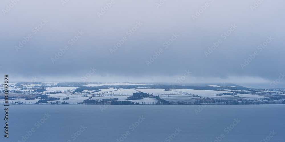 snow covered fields by the lake