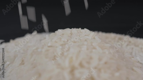 rice falling black background slow motion