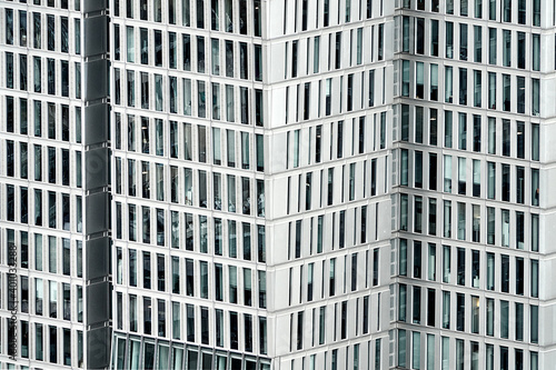 Facade of skyscraper with elongated rectangular windows, abstract colorless image