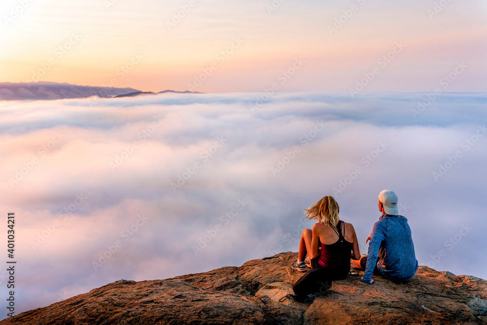 Couple Above the Foggy Layer of Clouds on Mountain Couple Above the Foggy Layer of Clouds on Mountain