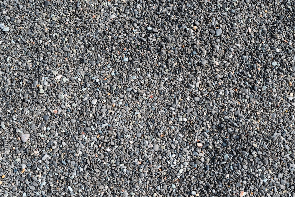 Close up full screen texture of fine gray limestone sea pebbles Close up full screen texture of fine gray limestone sea pebbles