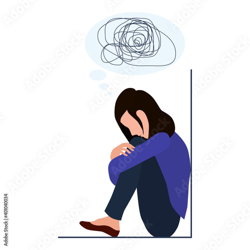 A woman is depressed with confused thoughts in her head. Mental disorder, search for answers, confusion concept. A young sad girl sits in the corner and hugs her knees unhappily.