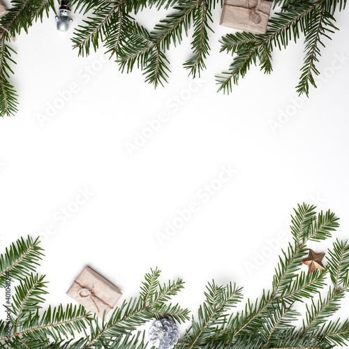 Christmas composition. Christmas gift  pine cones  fir branches on white. Top view  flat lounger  copy space.