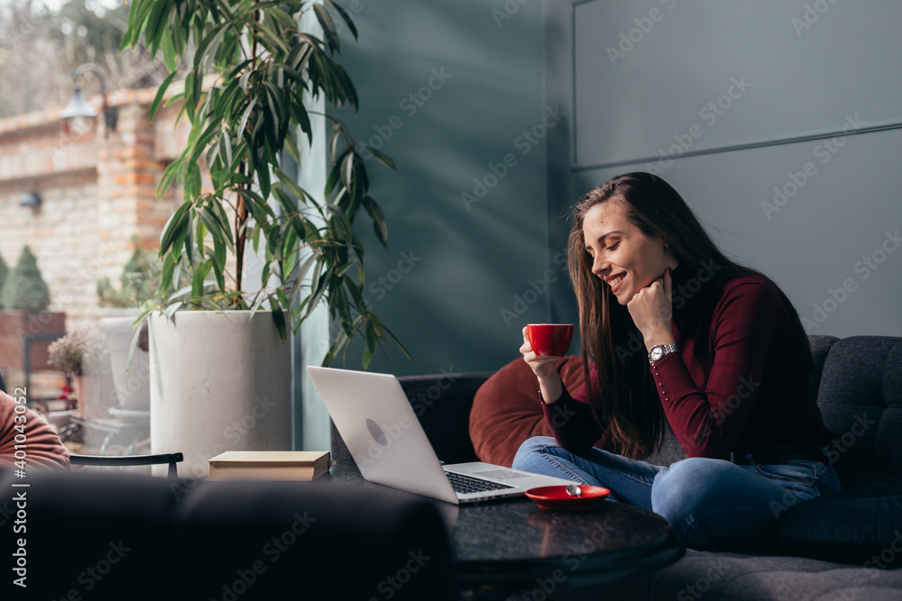 woman enjoying time working on laptop computer at her home - obrazy, fototapety, plakaty 