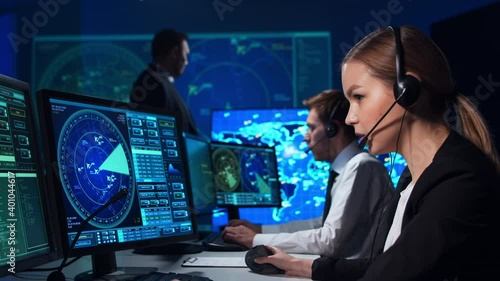 Workplace of the air traffic controllers in the control tower. Team of aircraft control officers works using radar, computer navigation and digital maps. Aviation concept.