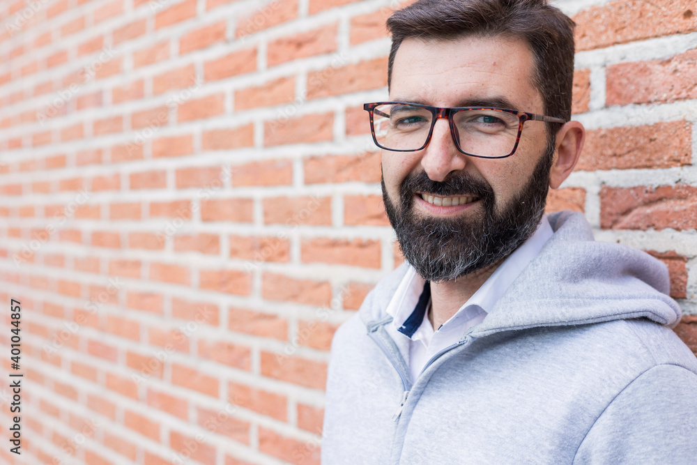 portrait of reliable man with brick wall glasses portrait of reliable man with brick wall glasses