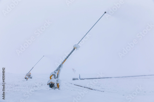 Devices for throwing snow on ski slopes