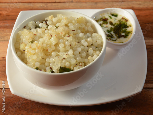 Sabudana khichdi / Khichadi is an Indian Fasting Food Recipe consume during navratri, ekadashi or ganesh chaturthi, dish isolated over a rustic wooden background, selective focus