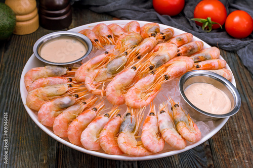 boiled shrimp on ice on dark blue table