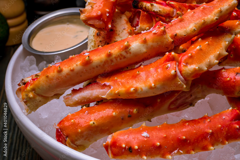 King crab claws on wooden table King crab claws on wooden table